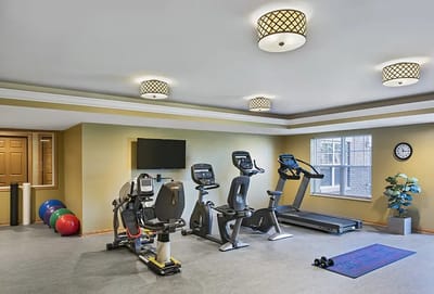 Fitness room with exercise equipment and decor