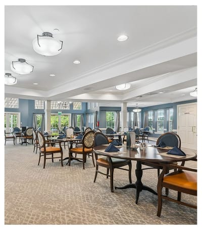 Elegant dining area with tables and chairs set for meals