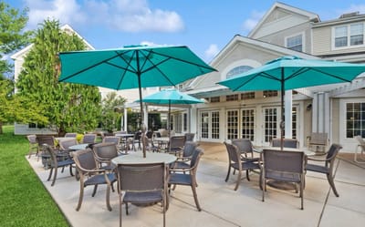 Outdoor patio area with turquoise umbrellas and seating