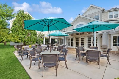 Outdoor seating area with umbrellas at Woodbridge Place