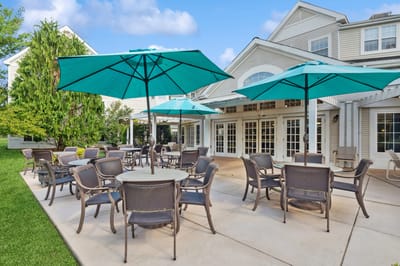 Outdoor seating area with umbrellas and landscaping