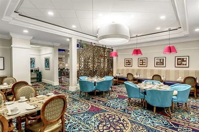 Dining room with colorful decor and tables set for meals.