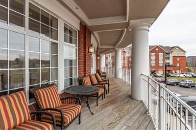 Outdoor balcony area with seating and scenic view