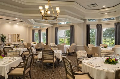 Elegant dining room setup with flowers and tables