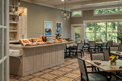 Bright dining room with a buffet of pastries and flowers