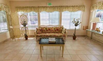 Cozy common area with floral couch and decor