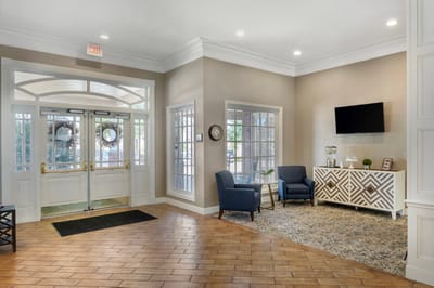 Bright lobby area with seating and an exit door