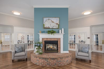 Comfortable seating area with a fireplace in senior living community