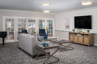 Bright common area with seating and piano