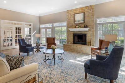 Bright, welcoming common area with seating and fireplace