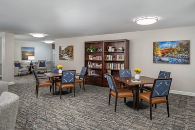 Common area with bookshelves and seating for residents