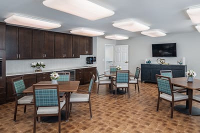 Bright and modern common area with tables and flowers