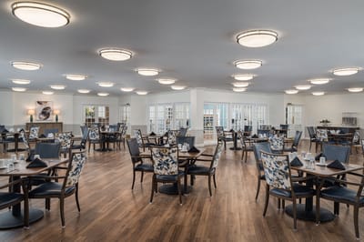 Bright and spacious dining room with tables and chairs