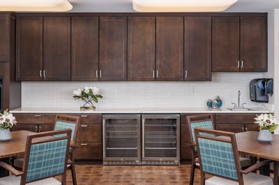 Modern kitchen area with seating and flowers