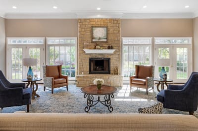 Bright and welcoming common area with seating and a fireplace