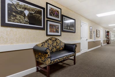 Interior hallway featuring framed artwork and seating