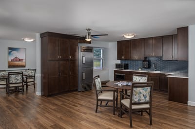 A well-furnished common area with a kitchen and dining space