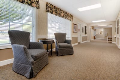 Interior view of a hallway with chairs and sunlight