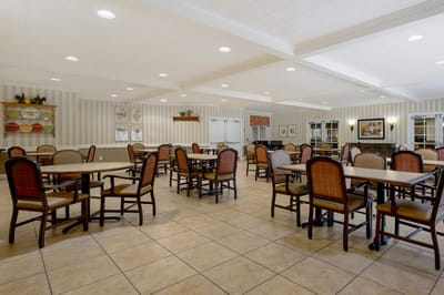 Dining area with tables and chairs in a bright setting