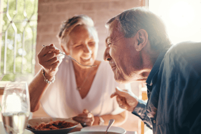 Two residents enjoying a meal together at a table