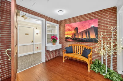 Welcoming interior entryway with a floral arrangement and seating