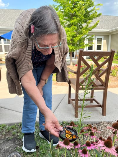 Resident engaging with nature in the garden