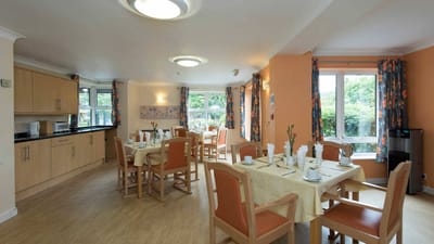 Interior dining area with set tables and natural light