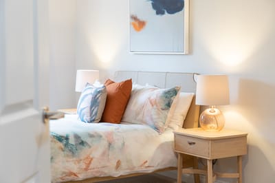 Cozy bedroom with decorative pillows and lamps