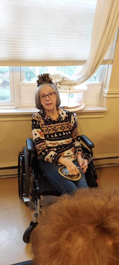 Resident celebrating with crown in a common area