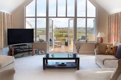 Bright common area with large windows and outdoor view