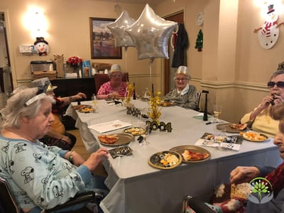 Residents celebrating with food and decorations indoors