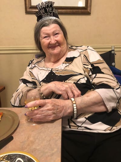 A resident celebrating New Year with a drink