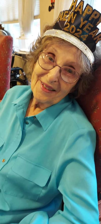A resident celebrating with a festive hat at the facility