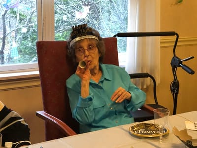 Resident celebrating New Year with a party horn