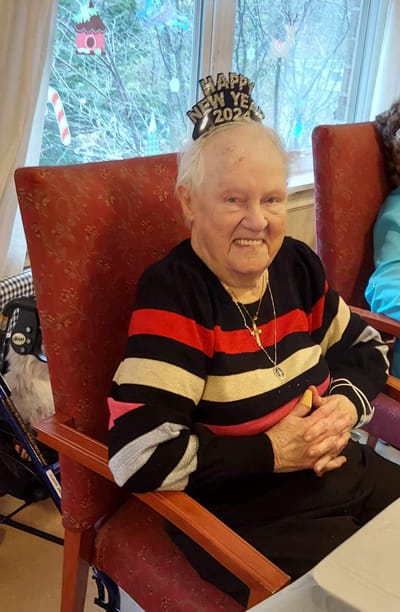 Senior resident celebrating New Year's with a festive hat