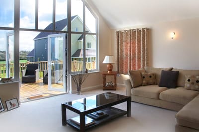 Interior view of a cozy living room with large windows