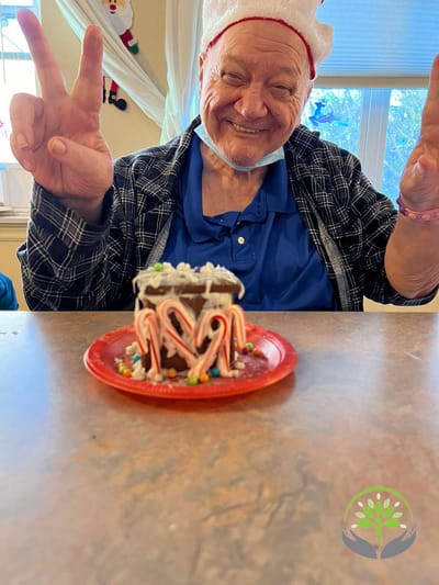 Resident smiling with a decorated dessert during a celebration
