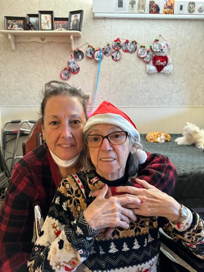 Resident with staff member in festive attire
