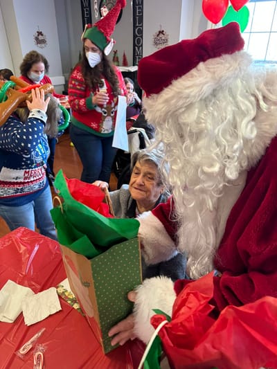 Residents celebrating with Santa during a holiday event