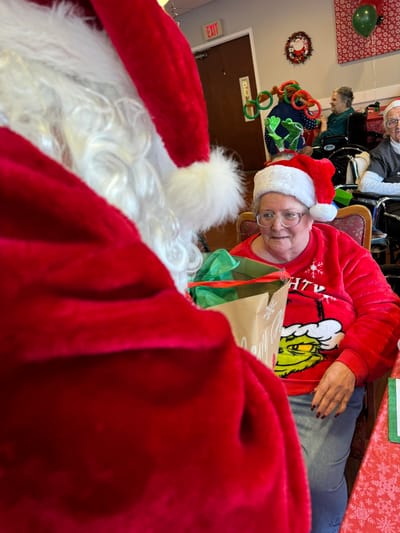 Resident interacting with Santa during a holiday event