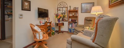 Cozy living room in a resident's suite with flowers and decor