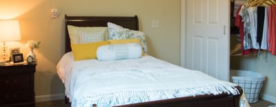 Cozy bedroom with a neatly made bed and closet