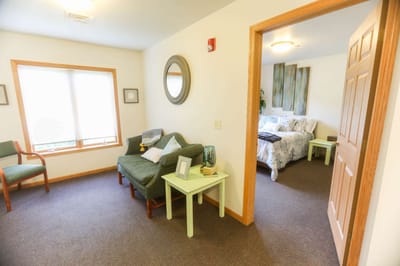 Cozy interior view of a resident room with a sofa and bed