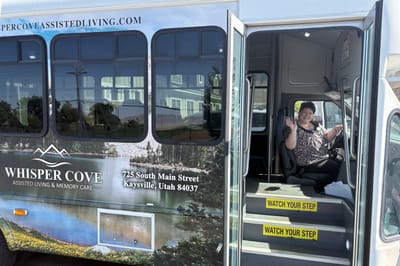 Staff member inside facility shuttle bus