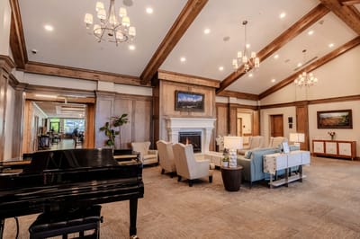 Bright interior common area with seating and piano