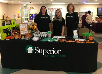 Staff members at a promotional event table.