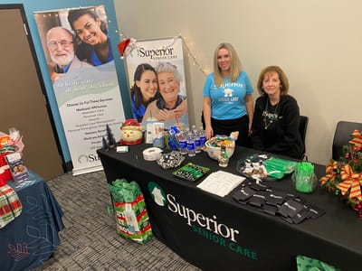 Staff members and a decorated table at an event.