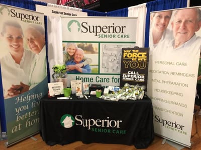 Display at a senior care event with promotional materials.