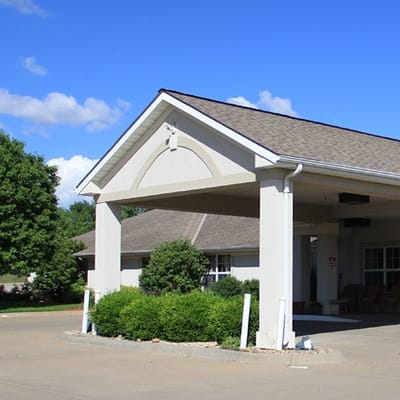 Exterior view of the facility entrance with landscaping.