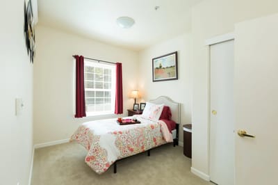 Cozy resident bedroom with bed and window.